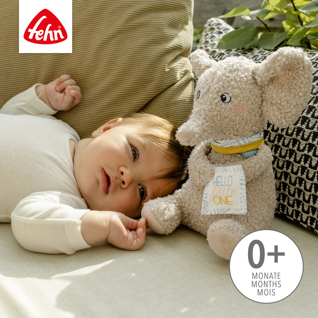 Baby spielt mit Baby Kuscheltier Elefant