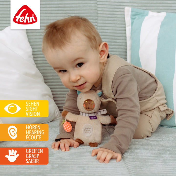 Baby spielt mit Baby Bean Bag Capybara