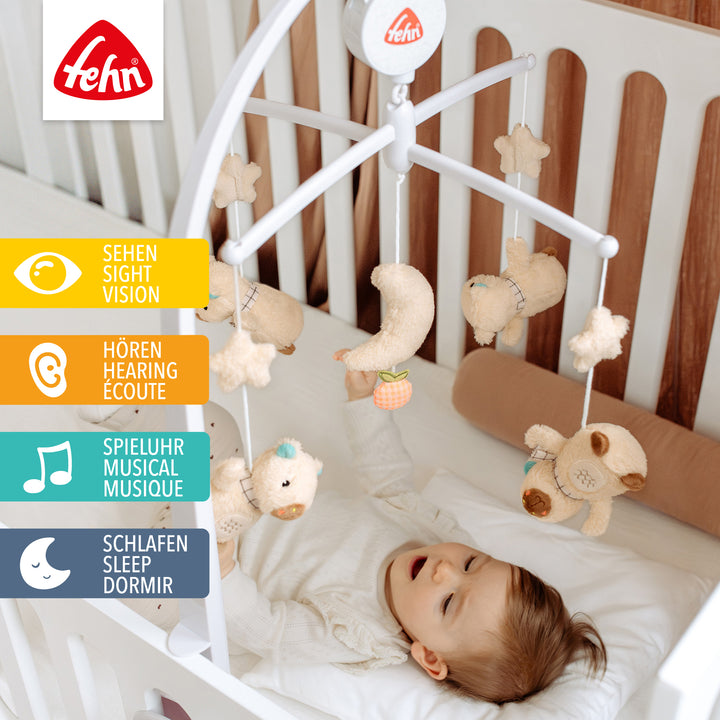 Baby liegt unter Baby Musik-Mobile Capybara