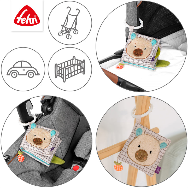 Baby Stoffbuch Capybara an Kinderwagen und Babyschale befestigt