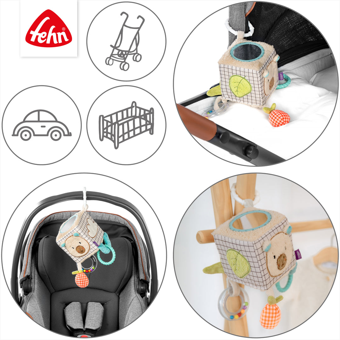 Baby Activity-Würfel Capybara an Kinderwagen und Babyschale befestigt