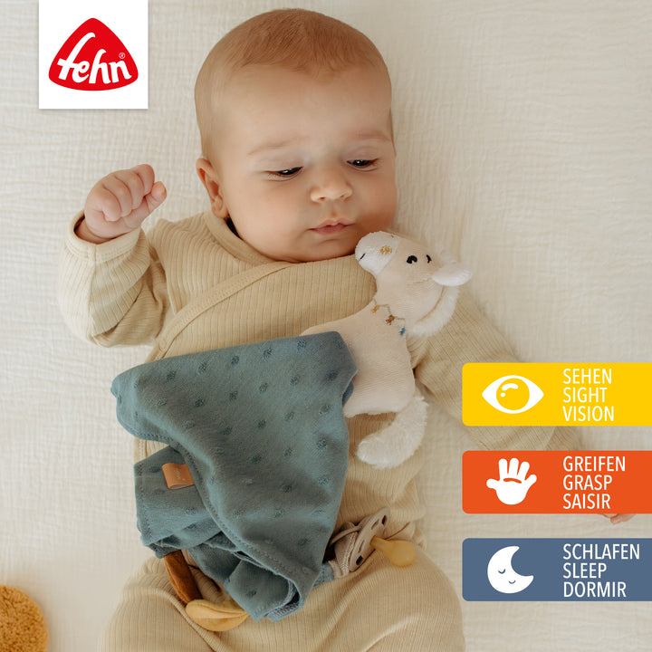 Baby spielt mit Baumwoll-Schmusetuch Pferd