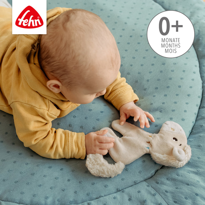 Baby spielt mit Baby Knister-Pferd