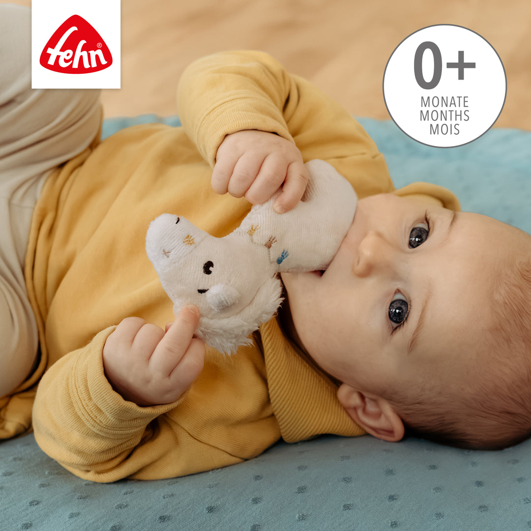 Baby spielt mit Baumwoll-Mini-Rassel Pferd