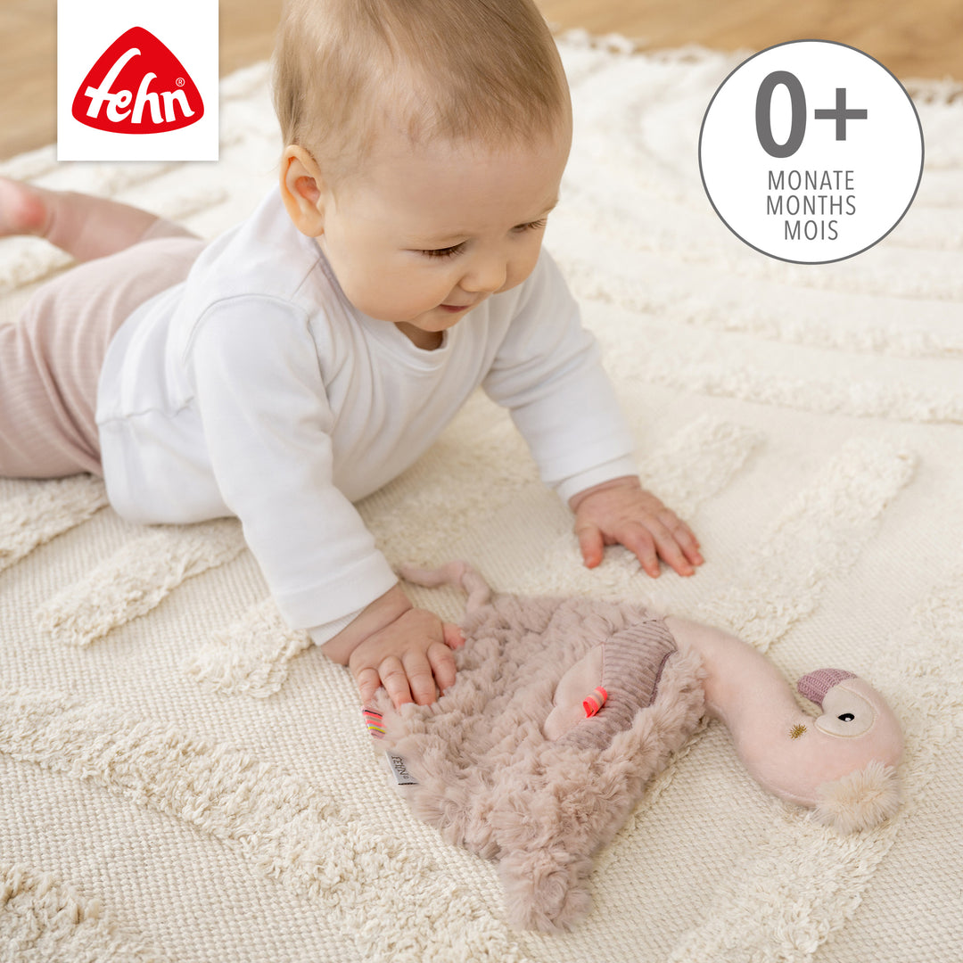 Baby spielt mit  Baby Schmusetuch Flamingo