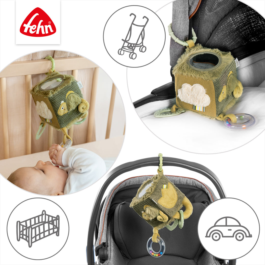 Baby Activity-Würfel Chamäleon an Babybett, Kinderwagen und Babyschale befestigt