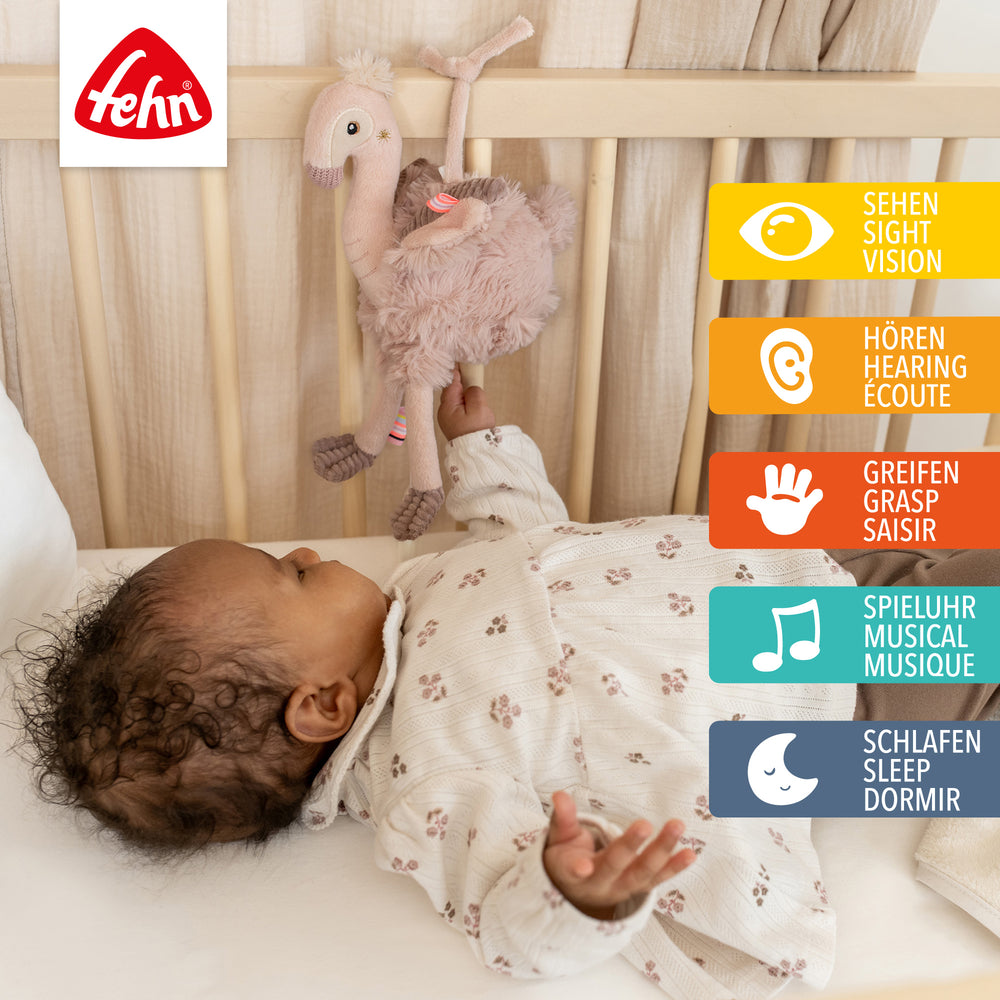 Baby Spieluhr Flamingo am Babybett befestigt