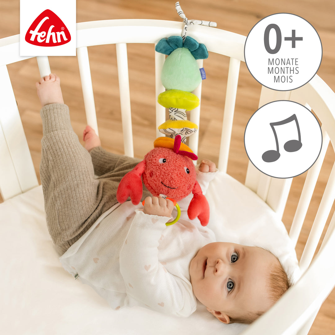 Baby Spieluhr Hummer am Babybett befestigt