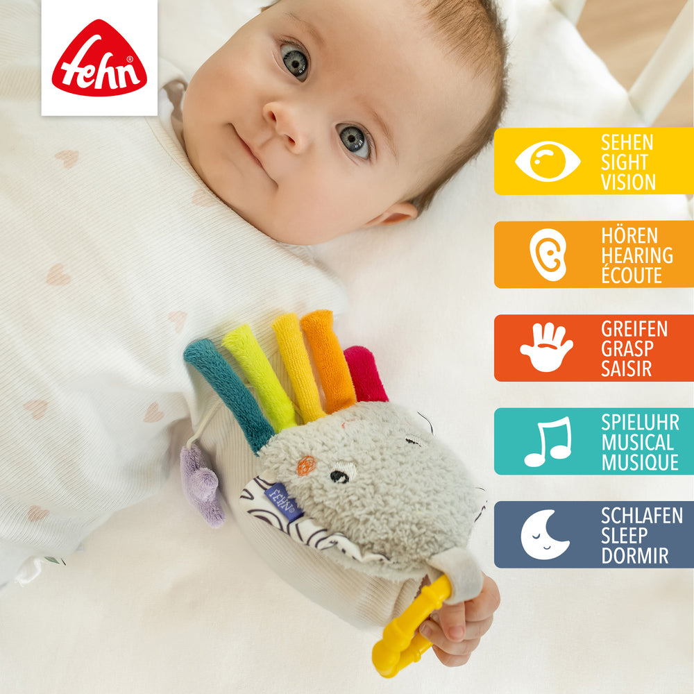 Baby spielt mit Baby Spieluhr Tintenfisch