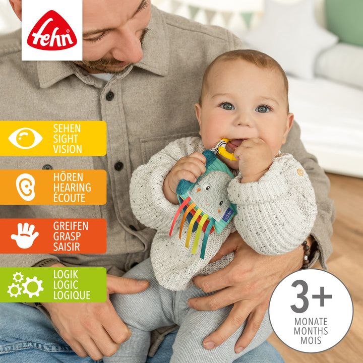 Baby spielt mit Baby Mini-Knisterbuch Tintenfisch