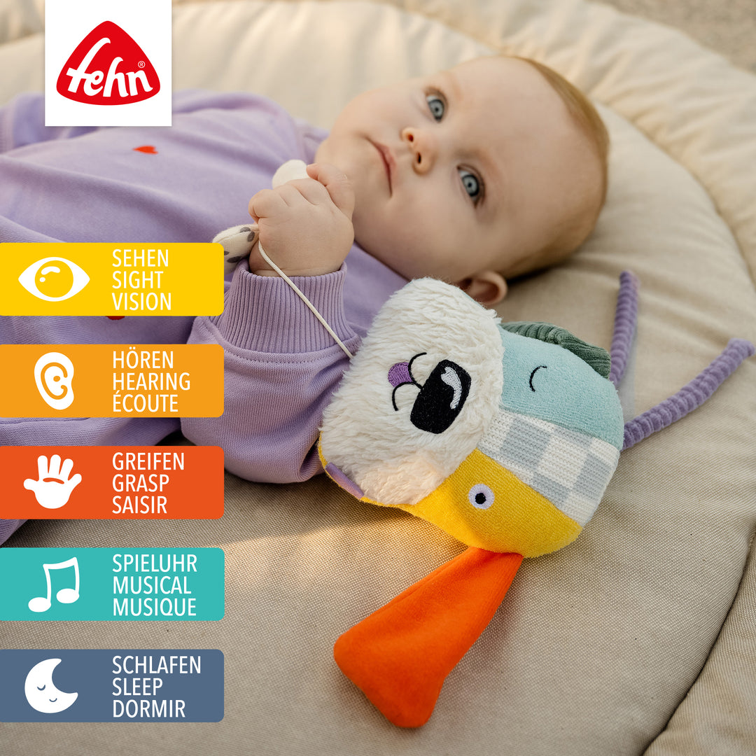 Baby spielt mit Baby Spieluhr Hund