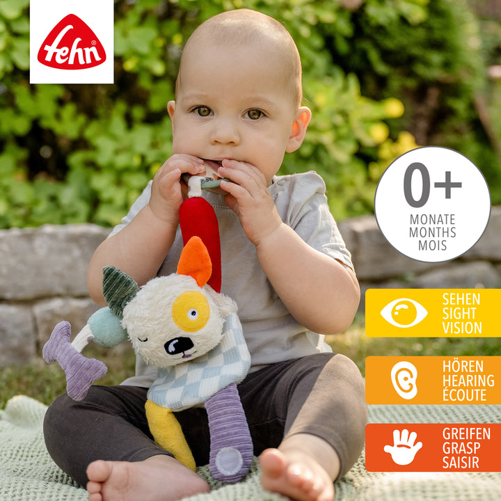 Baby spielt mit Baby Activity-Hund aus weicher Baumwolle