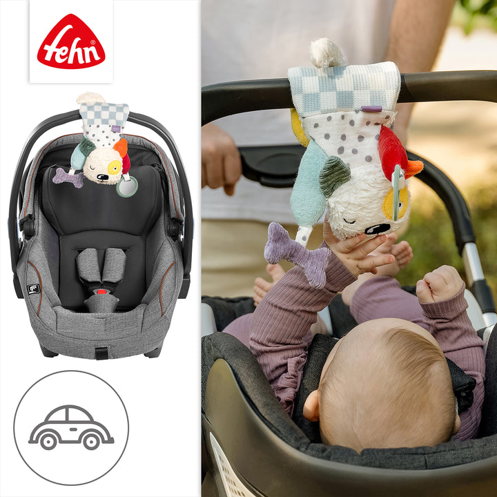 Baby Activity-Hund an Babyschale befestigt