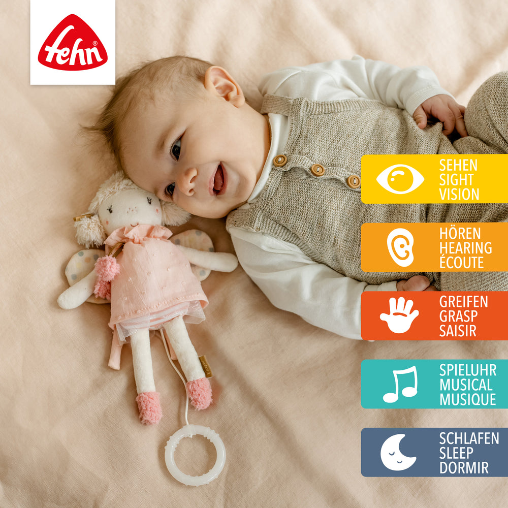 Baby spielt mit Baby Spieluhr Fee