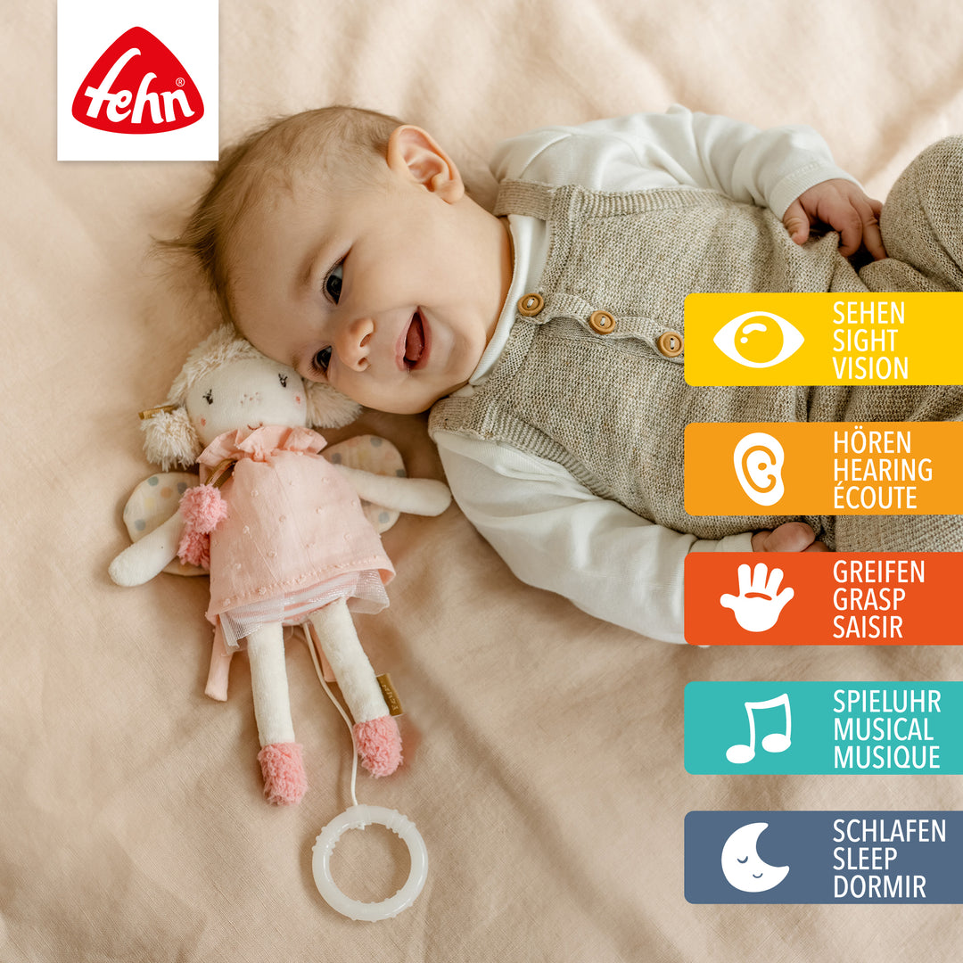 Baby spielt mit Baby Spieluhr Fee