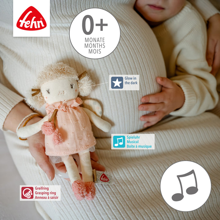 Mutter mit Baby hält Baby Spieluhr Fee