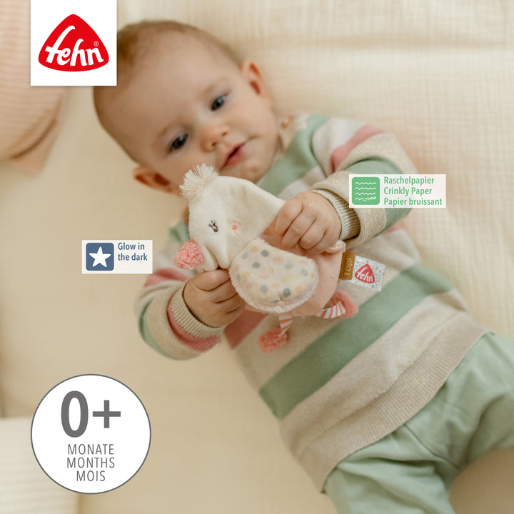 Baby spielt mit Baby Knister-Vogel mit Glow in the dark-Bestickung