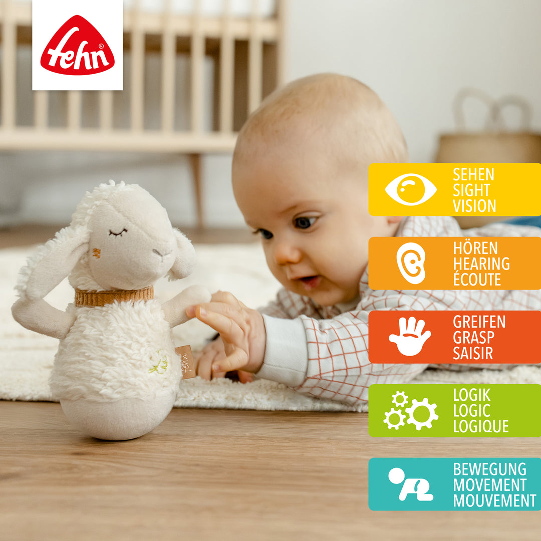 Baby stupst Baby Mini-Stehauf Schaf an