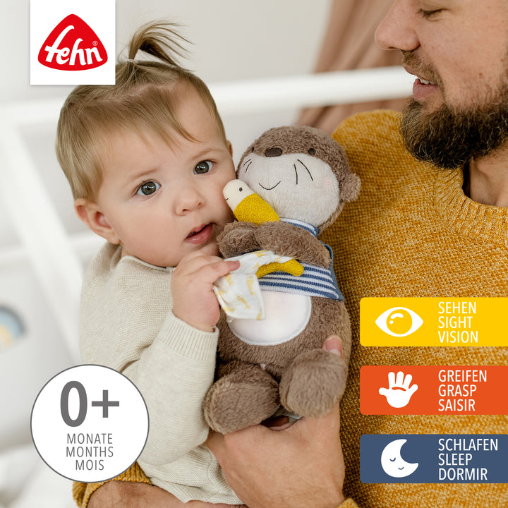 Vater hält Baby mit Baby Nachtlicht Otter