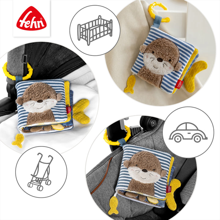 Baby Stoffbuch Otter an Kinderwagen und Babyschale befestigt