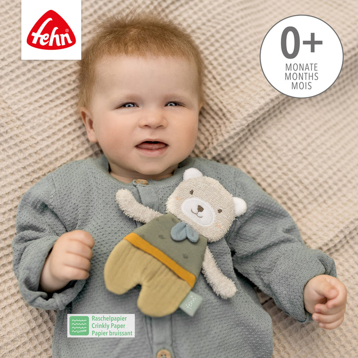 Baby spielt mit Baby Knister-Bär