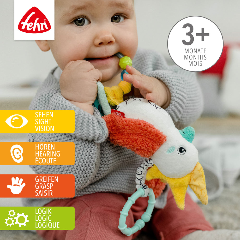 Baby spielt mit Baby Zwitscher-Vogel aus weichem Plüsch