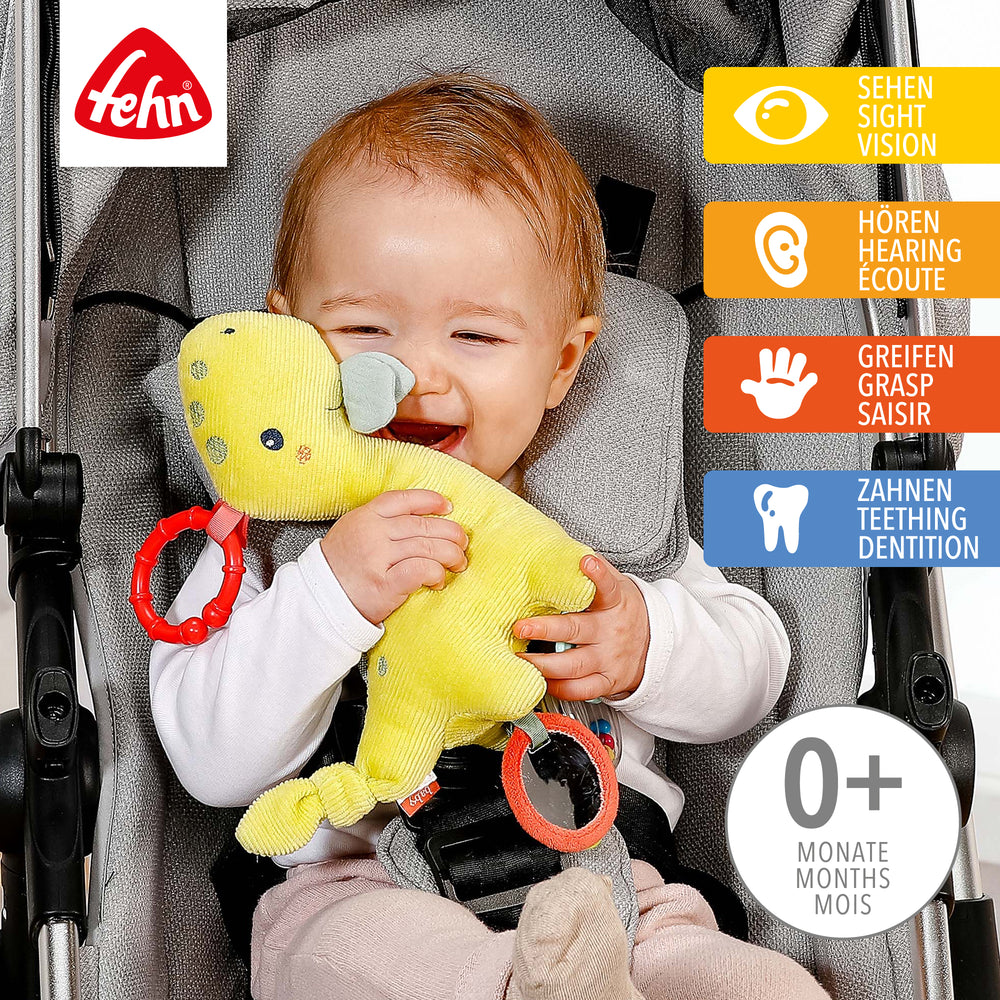 Baby spielt mit Baby Activity-Dino aus weichem Kord