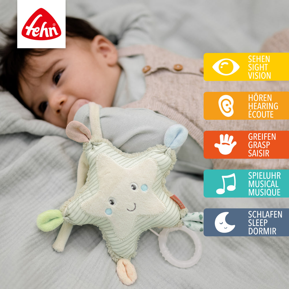 Baby spielt mit Baby Spieluhr Seestern