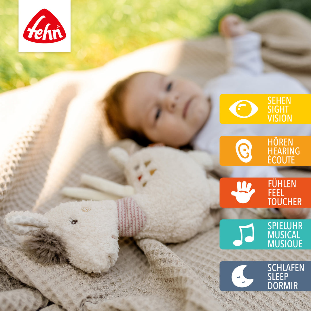 Baby spielt mit Baby Spieluhr Lama