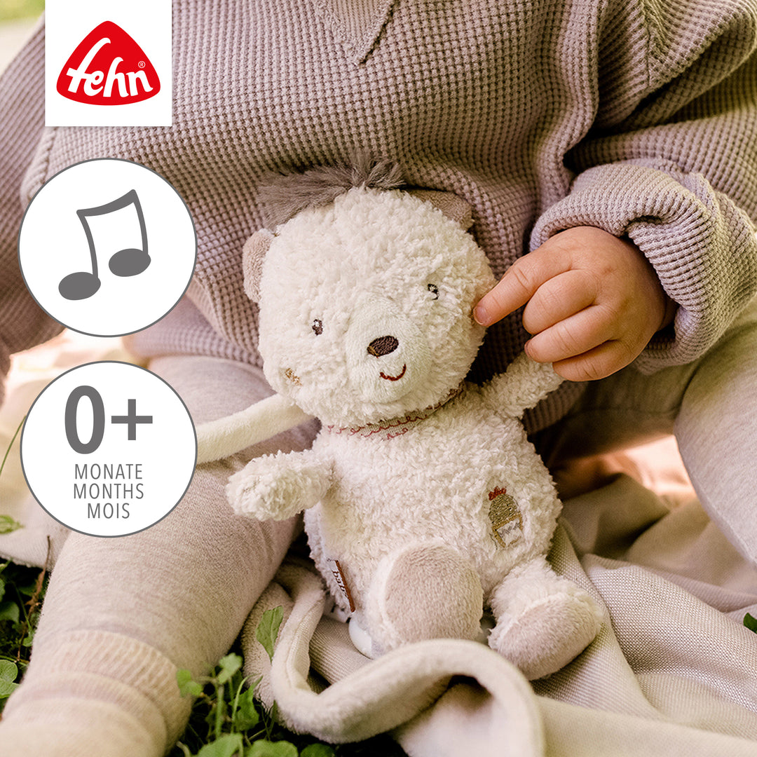 Baby spielt mit Baby Spieluhr Bär