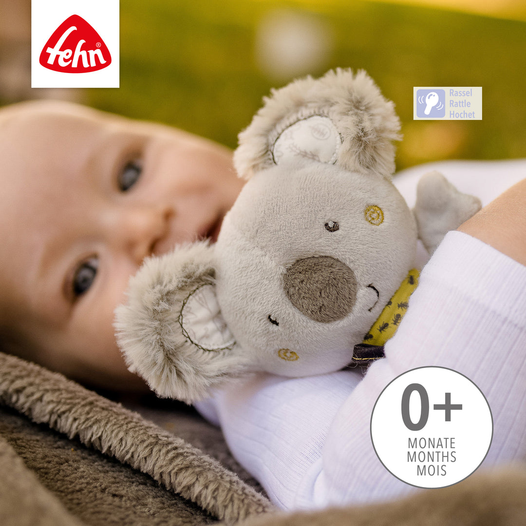 Baby hält Baby Ring-Greifling Koala im Arm