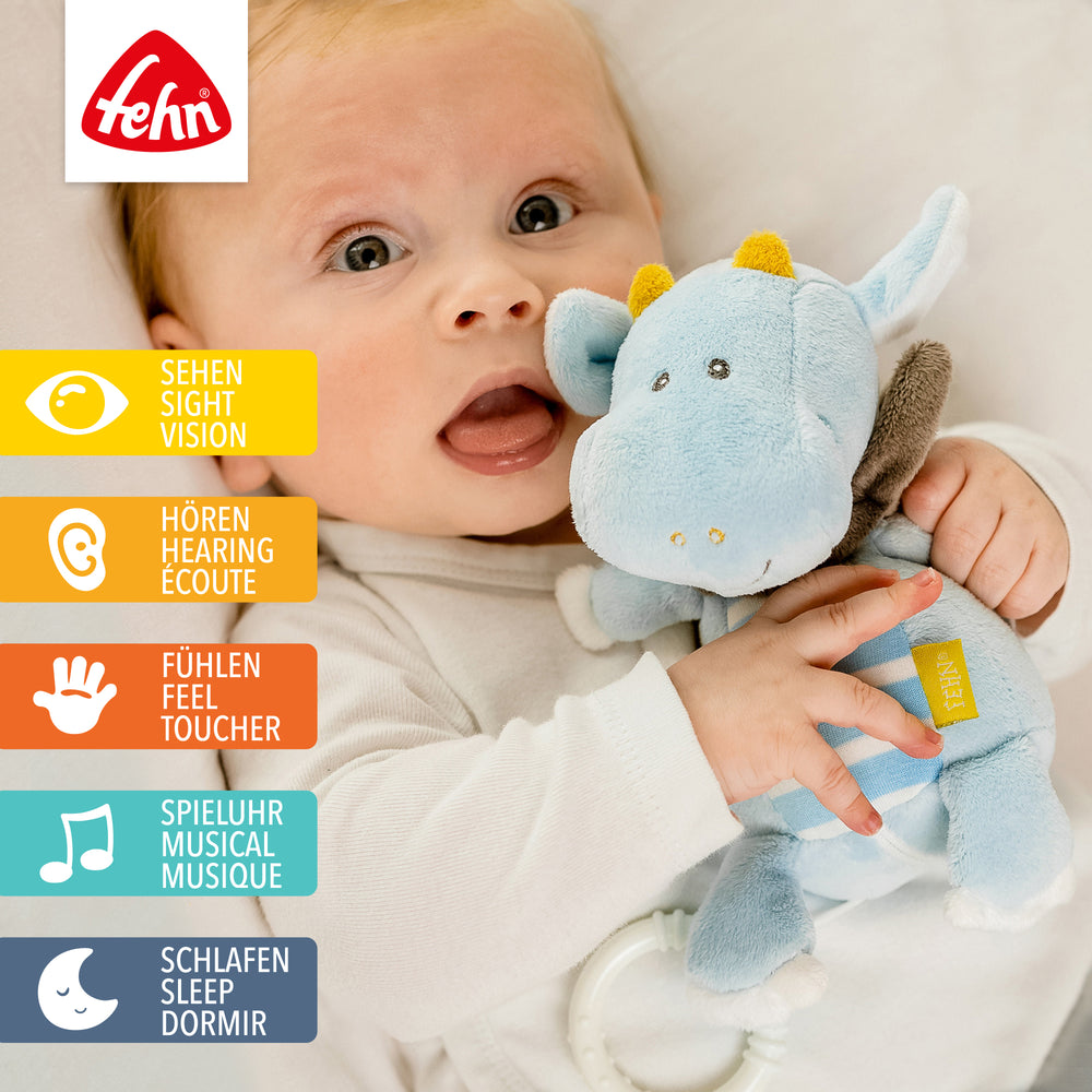 Baby spielt mit Baby Spieluhr Drache