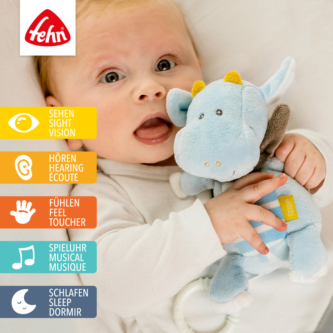 Baby spielt mit Baby Spieluhr Drache