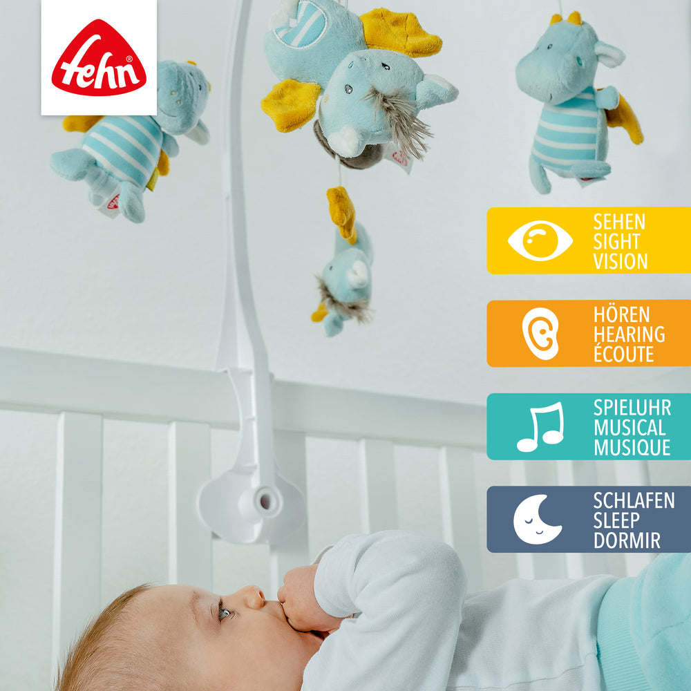Baby liegt unter Baby Musik-Mobile Little Castle