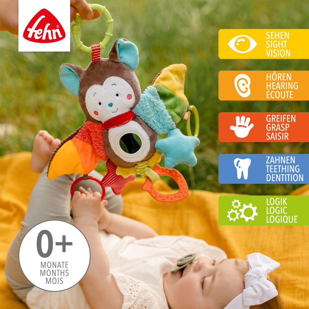 Baby spielt mit Baby Activity-Fledermaus aus weichem Plüsch