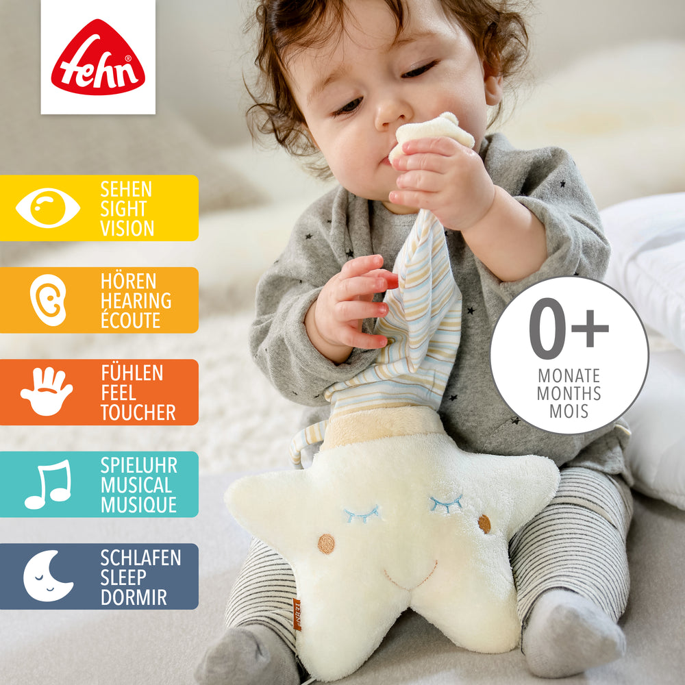 Baby spielt mit Baby Spieluhr Stern