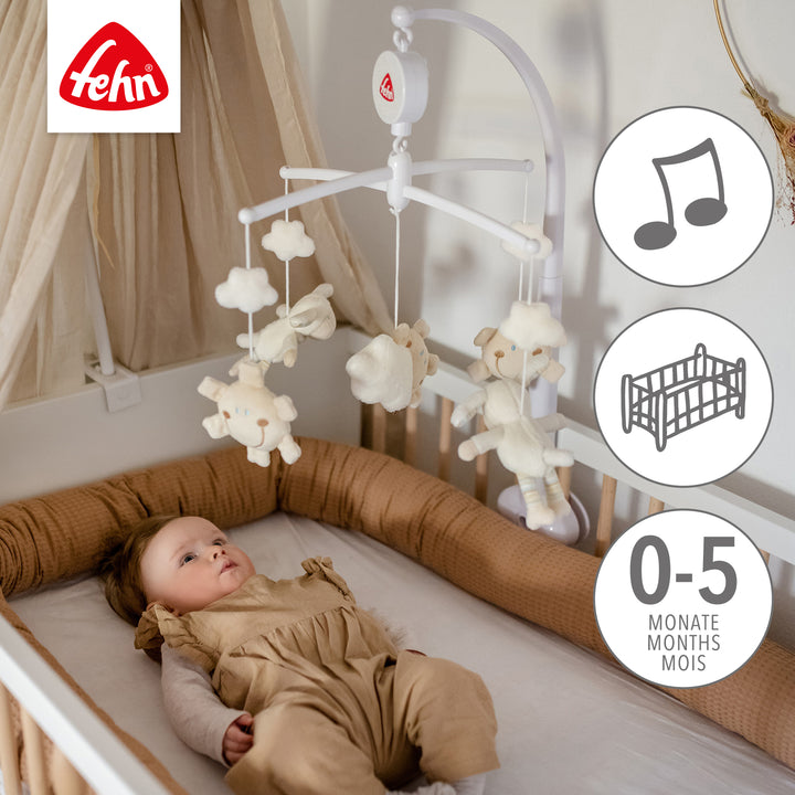 Baby liegt unter Baby Musik-Mobile Schaf
